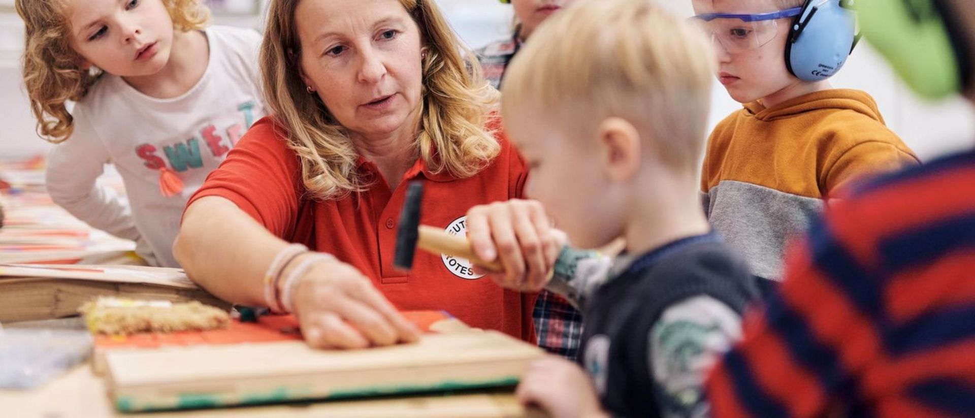 Erzieherin unterstützt Kinder im Bauraum.